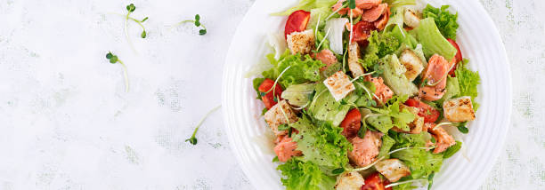 istock Caesar Salad with Salmon. Fish menu. Seafood - salmon. Top view, overhead, banner 1193687135