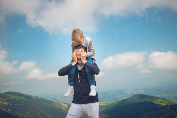 istock Father and son having fun on a mountain peak. 1193688638