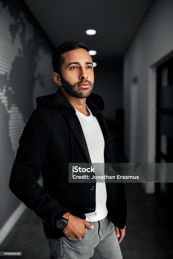 Handsome Trendy Gen Z Indian Arabic Man Standing Looking Into The Distance  Wearing Black Jacket And Hand In Pocket Stock Photo - Download Image Now -  iStock