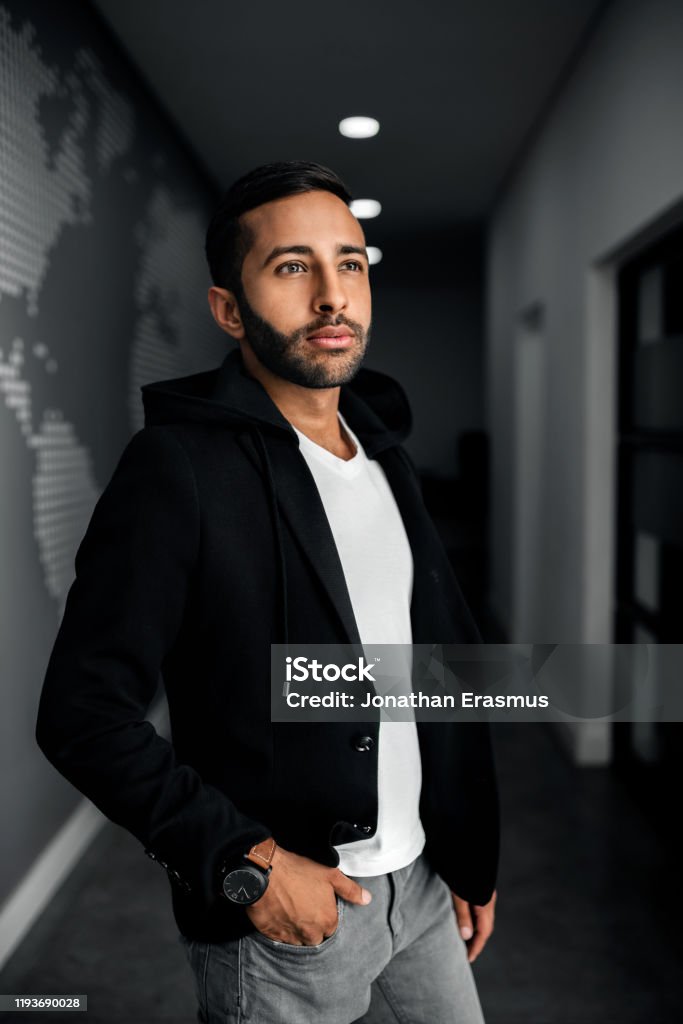 Handsome Trendy Gen Z Indian Arabic Man Standing Looking Into The Distance Wearing Black Jacket And Hand In Pocket Stock Photo - Download Image Now - iStock Handsome Trendy Gen Z Indian Arabic Man Standing Looking Into The Distance Wearing Black Jacket And Hand In Pocket Stock Photo - Download Image Now - iStock
