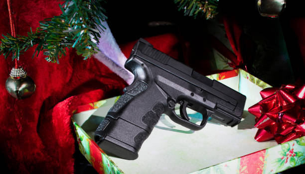 istock Gift of a pistol in a box under the Christmas tree 1193690051