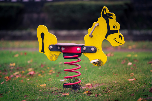 Horse-shaped swing in a children's playground.