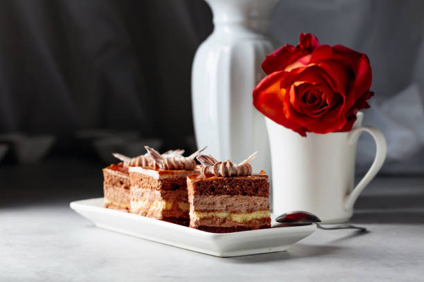 Layered cakes with rose on a white marmorean table. Romantic breakfast.