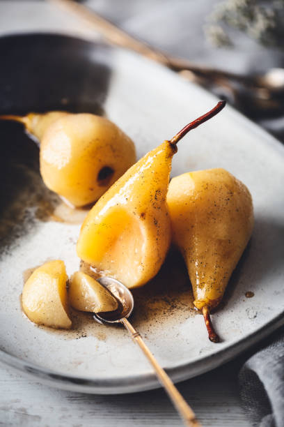 Roasted Pears with Honey, Vanilla and Sweet White Wine Roasted Pears with Honey, Vanilla and Soft White Wine pear dessert stock pictures, royalty-free photos & images