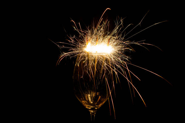 istock Three sparklers in a wine glass on a black 1193691785