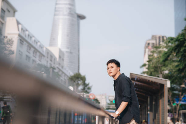 istock Young asian man waiting for a public bus 1193692820