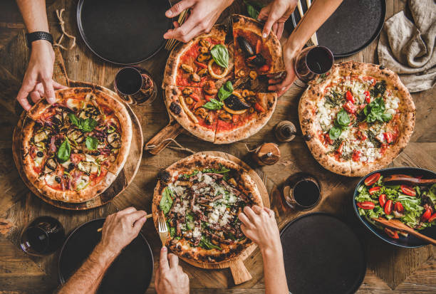 istock Flat-lay of people having pizza party dinner with red wine 1193692859