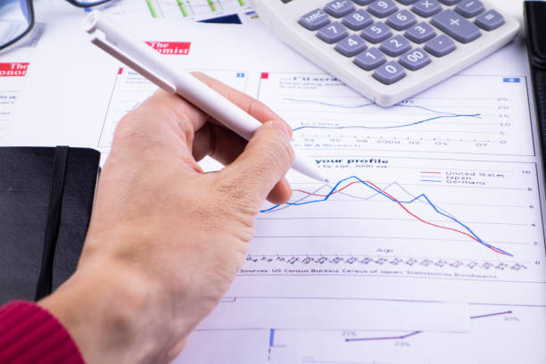 istock There are pens, calculators and magnifiers on the chart 1193695013