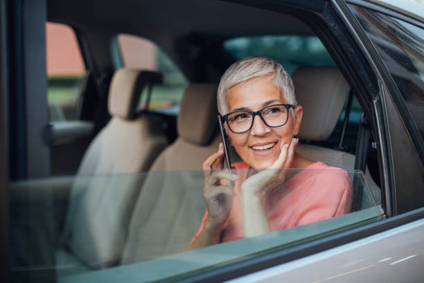 istock Businesslady sitting on the back seat 1193700258
