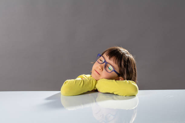 istock calm happy child sleeping on desk to meditate for idea 1193700496