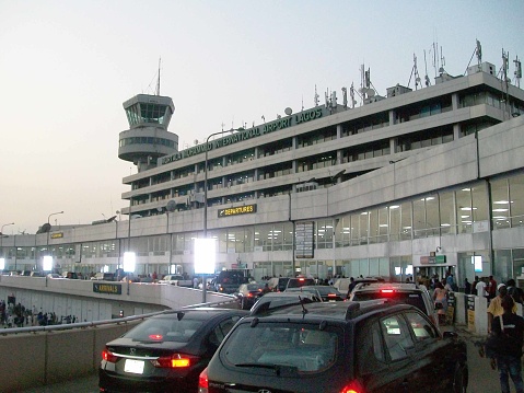 Scene Of Land Vehicle, People Walking With Travelling Bag, Standing, Talking To One Another And More In Front Of Murtala Muhammed International Airport In Lagos State Nigeria West Africa