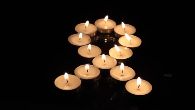 Close-up of small burning candles