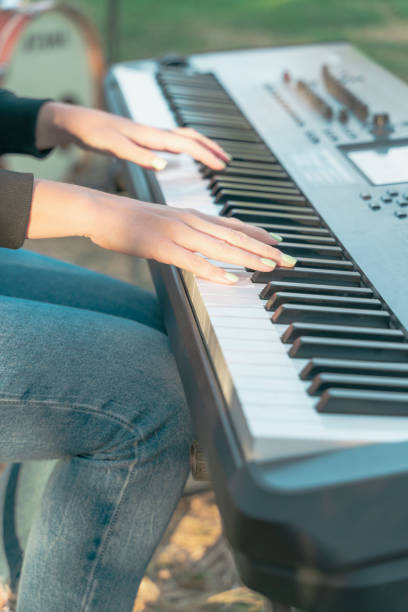istock Girl playing piano keyboard, hand close-up 1193701561