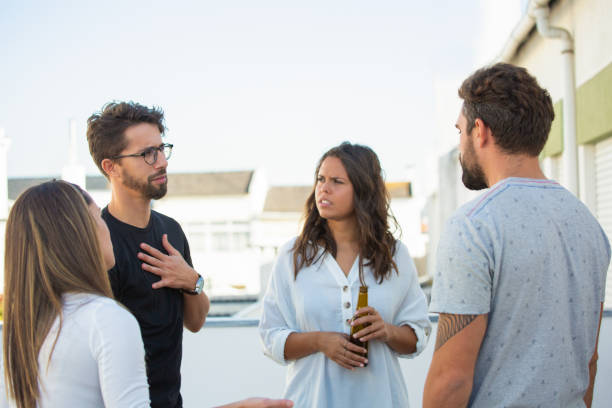 gruppo di amici che condividono notizie sulla bottiglia di birra all'aperto - back lite foto e immagini stock