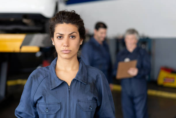 A Handsome mechanic job woman in uniform working on car