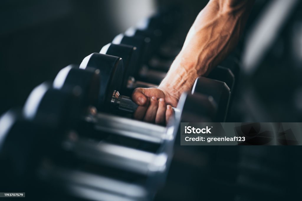 Rows of dumbbells in the gym with hand Gym Stock Photo