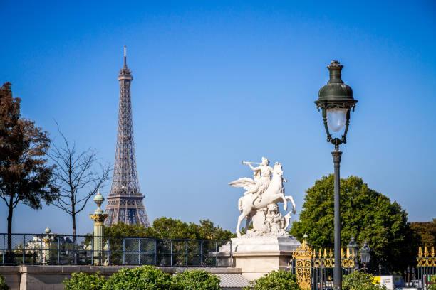 Fame straddling Pegasus statue and Eiffel Tower view from the Tuileries Garden, Paris, France