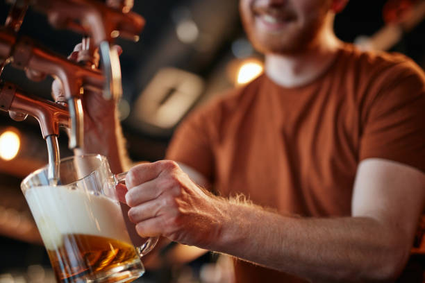 istock Close up of caucaisan ginger bartender pouting beer at pub. 1193709184