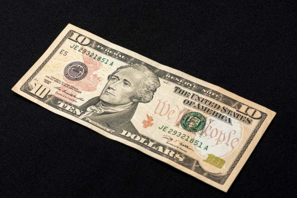 istock Ten american dollars on a black background. 1193709876