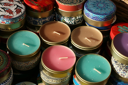 Scented candles in traditional patterned boxes