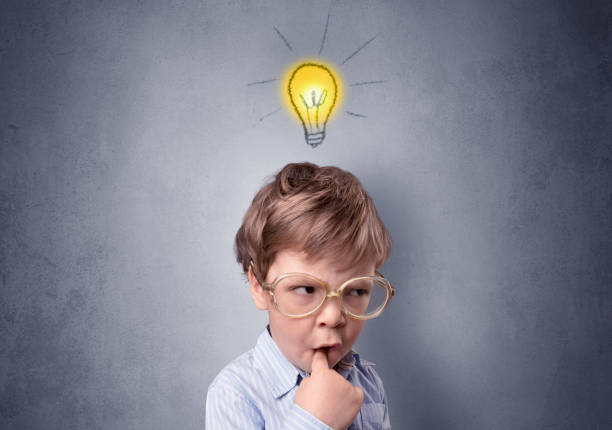 istock Little boy mull over with bulb above his head 1193710235