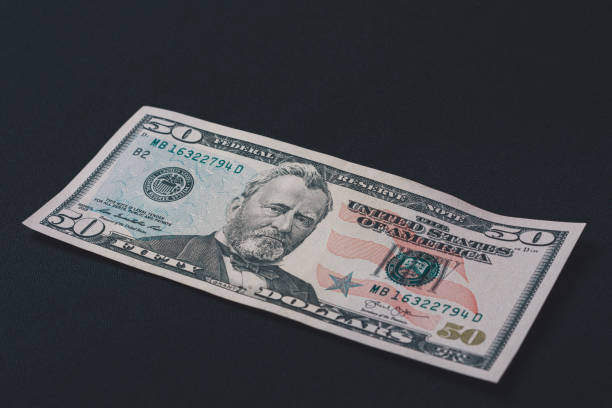 istock Fifty dollars banknote, isolated on black background, place for inscription. 1193711487