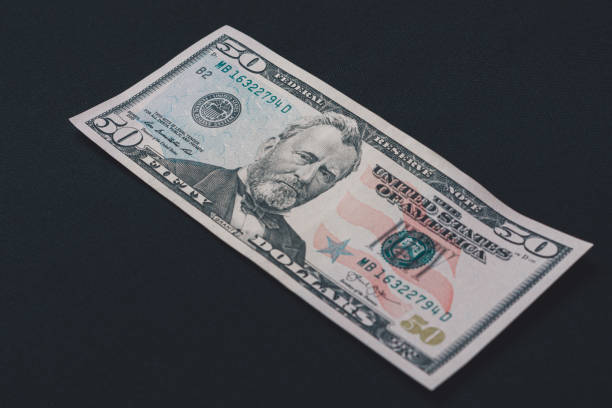 istock Fifty dollars banknote, isolated on black background, place for inscription. 1193711493