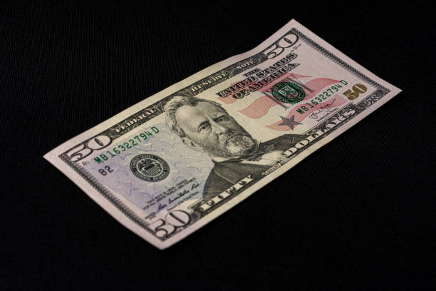 istock Fifty dollars banknote, isolated on black background, place for inscription. 1193711533