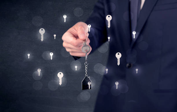 istock Businessman holding keys with keys around 1193711934