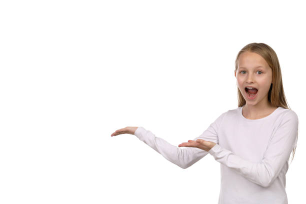 Girl against a white background points to the side