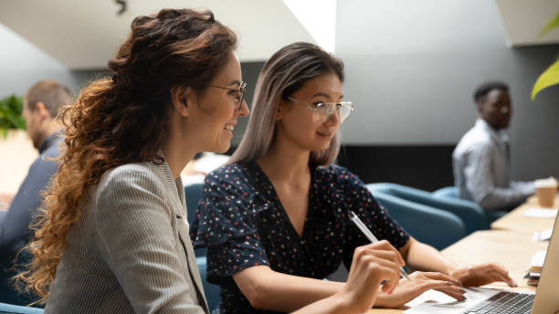 istock Asian coach mentoring millennial newbie intern in office. 1193712961