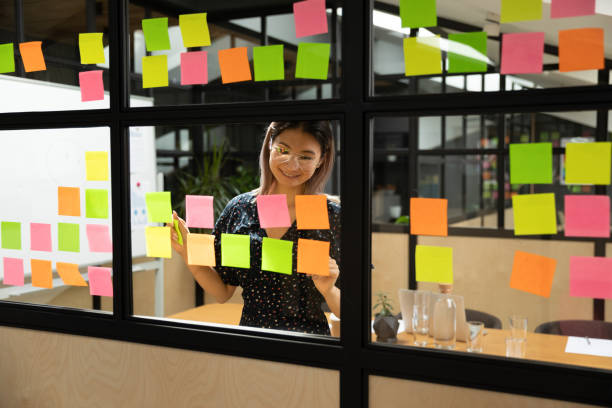 istock Smiling asian female project manager in eyewear organizing working process. 1193713022