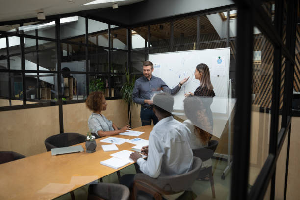 istock Confident multiracial speakers presenting project ideas to mixed race investors. 1193713049