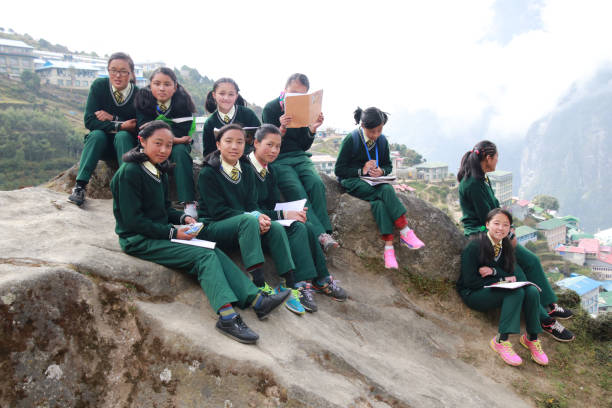 Group of Female students sitting outdoor and reading book in Namche bazaar village Namche bazaar is famous place with market and hotel for tourist located in khumbu area.Nepal 1 october 2018:Group of Female students sitting outdoor and reading book in Namche bazaar village Namche bazaar is famous place with market and hotel for tourist located in khumbu area.Nepal central asian ethnicity stock pictures, royalty-free photos & images