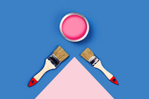 istock Two-toned background with pink paint jar and brushes. 1193717669
