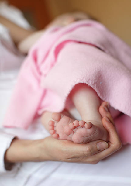 istock Nursing baby while the mother holds her feet 119371809
