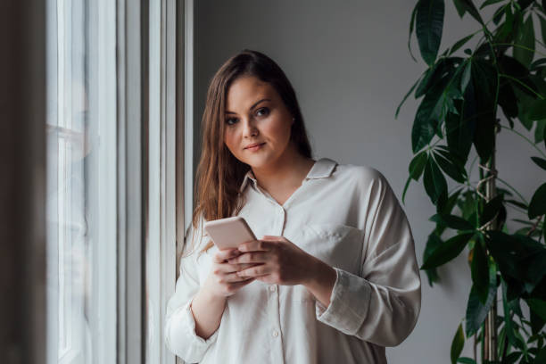 istock Pretty Plus Size Woman Using her Cell Phone 1193720711