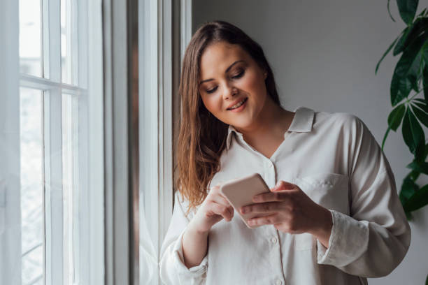 istock Pretty Plus Size Woman Using her Cell Phone 1193720737