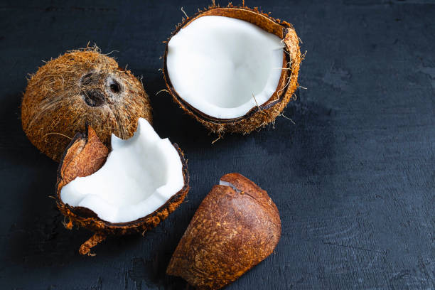 istock Coconut cut in half on a black background 1193721554