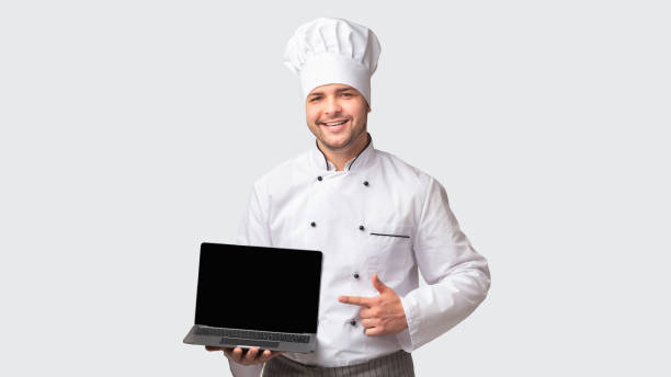 istock Chef Man Holding Laptop With Blank Screen Standing, White Background 1193721656