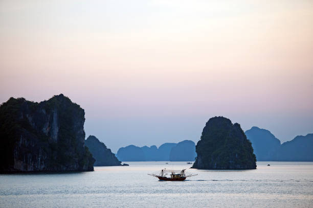 istock Last light behind trawler, Ha Long Bay, North Vietnam 1193722657