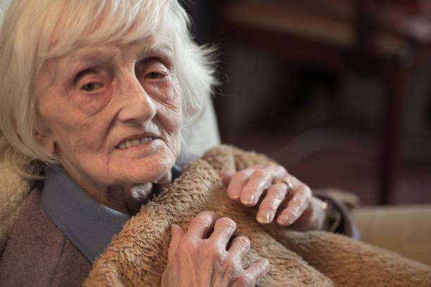 istock An elderly woman feeling cold at her home during the winter months. 1193723361
