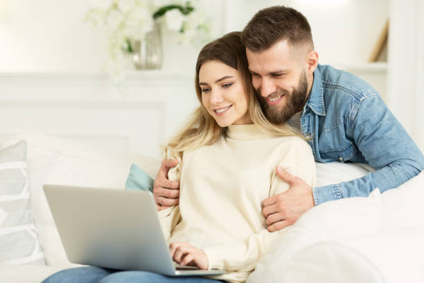 istock Loving couple browsing social media on laptop 1193725094