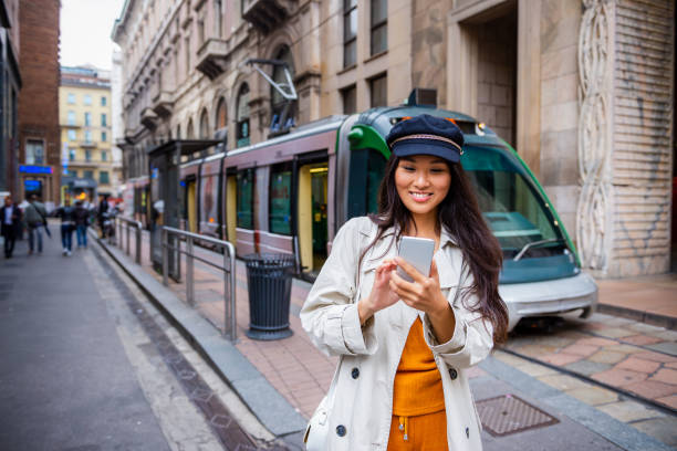 istock Smiling Chinese tourist using mobile phone 1193725328