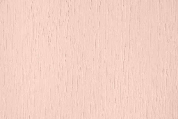 Pale pink colored low contrast Concrete textured background with roughness and irregularities