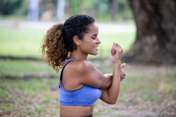 istock Young Woman Exercising While Sitting On Grass 1193725630