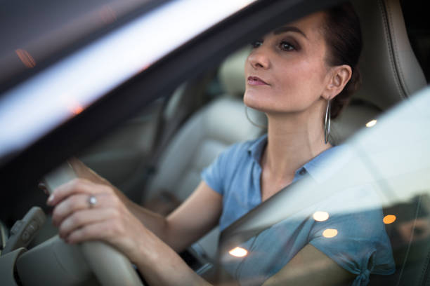 istock Pretty, young woman  driving a car 1193725846