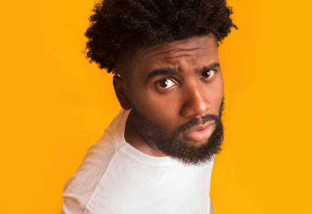 istock Handsome black man suspiciously looking at camera 1193726473