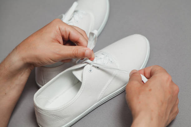 istock Hands tie  lace on new white sneaker 1193728156