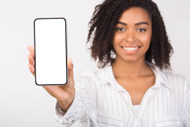 istock Black millennial woman showing blank phone screen 1193728658